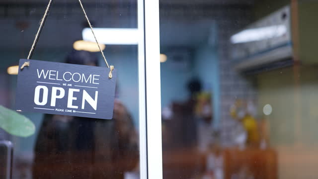 On the door of a café, there is an open sign.