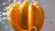 istock Orange falling apart into slices. Super slow motion 1143521363