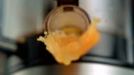 istock Orange juice pouring out of juicer. Super Slow motion 1147315381
