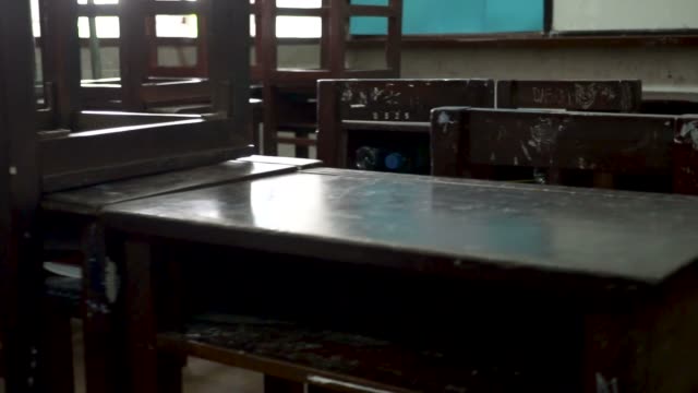 Panning video shot of old classroom towards the whiteboard in public school in Thailand