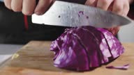 istock Professional chef cutting up a half of red cabbage head 1371897893