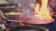 istock SLO MO. Professional chef stirs and flips beef strips in a pan over a flaming stove in a commercial kitchen at a diner. 1149914102