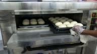 istock Raw burger bun keep inside a big micro oven 4k smooth motion clip video. 1392802860