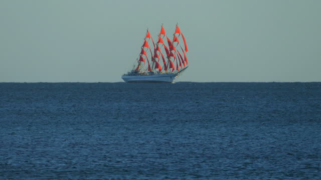 sailboat on red sails in a strong wind