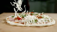 istock SLO MO Scattering the cheese over the pizza 977197810