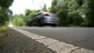 istock Scene low level angle camera of car drive through on the road 1282410166