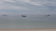 istock Scenic view of sea and coastline, fishing boats 1364954597