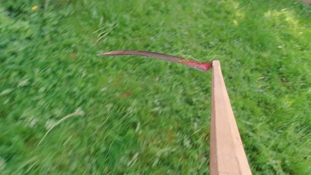 Scythe Mowing Grass Slow Motion