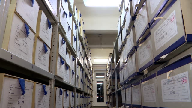 Shelves with boxes in archive. Storage of documents.
