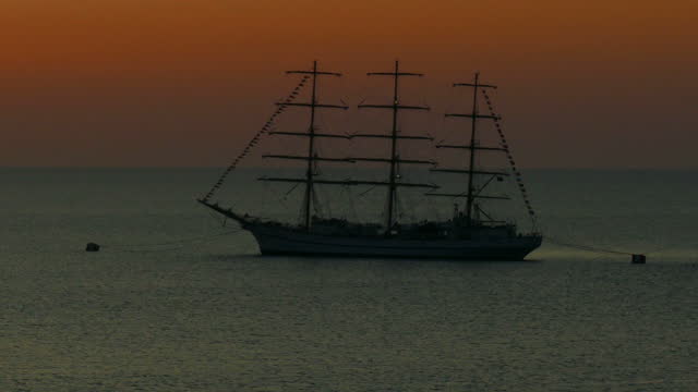 silhouette of a beautiful old sailing ship at sunset