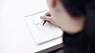 istock Sketching a comic in notebook 1301952249