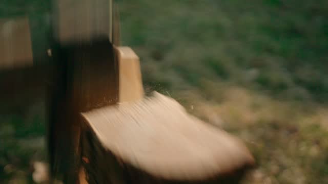 Slow motion:Splitting Wood With An Axe with sun background