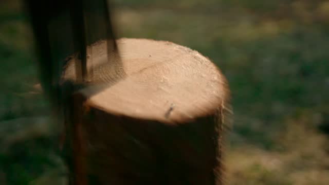 Slow motion:Splitting Wood With An Axe with sun background