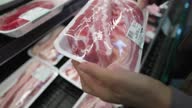 istock super market shopper hands picks up packaged fresh pork belly 1327554366