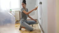 istock Teenage girl painting walls 1192187095