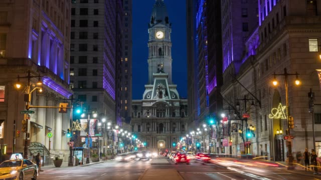 4K Time lapse of Philadelphia's landmark historic City Hall building at twilight time with car traffic light, United States of America or USA, history and culture for travel concept