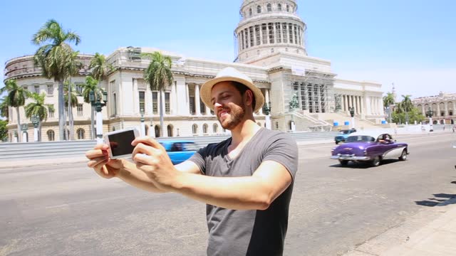 Tourist taking selfie photos in downtown of Havana, Cuba