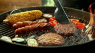 istock SLO MO LD Turning meat while grilling 606086974