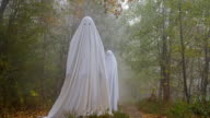 istock Two scary ghosts in the woods 858369696