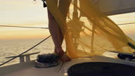 istock SLO MO Unrecognizable woman in long yellow dress walks on a deck of a sailboat 1366415433