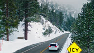 istock Van Driving Down a Snowy Mountain Road - Aerial 1308318431