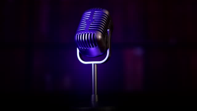 Vintage microphone spinning under colored lights