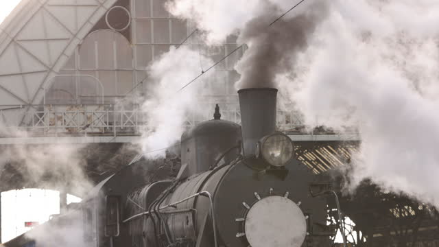 Vintage steam train locomotive, locomotive wheels. Steam train departs
