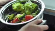 istock Washing broccoli and cherry tomato slow motion video 928119736