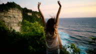 istock Woman on cliff with view on  ocean in Bali 953027458