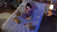 istock woman shopping online on bed 1350207080