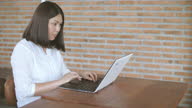 istock Woman working and using with laptop at cafe , SLOW MOTION 1297573833