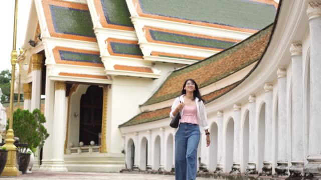 Women traveler enjoy travel in temple near hometown for relaxation. Travel destination concept.