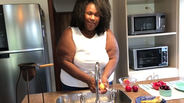 44 year old large build black woman having a snack