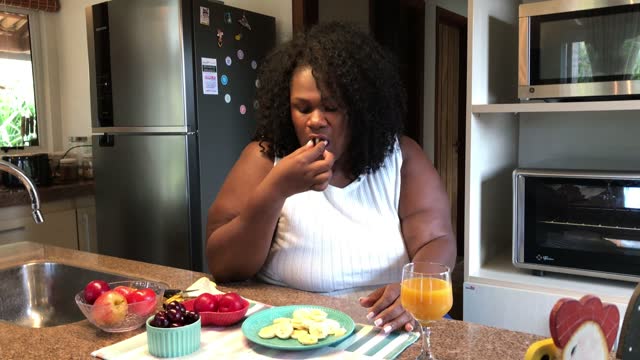 44 year old large build black woman having a snack