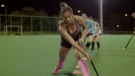 istock Young female field hockey players practicing sports drill on field 850975010