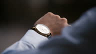 istock Young male business man is waiting for a meeting Hand with clock close up Looks at the clock time 1281296752
