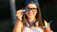 istock Young Urban Woman Playing With Fidget Spinner 1372033299